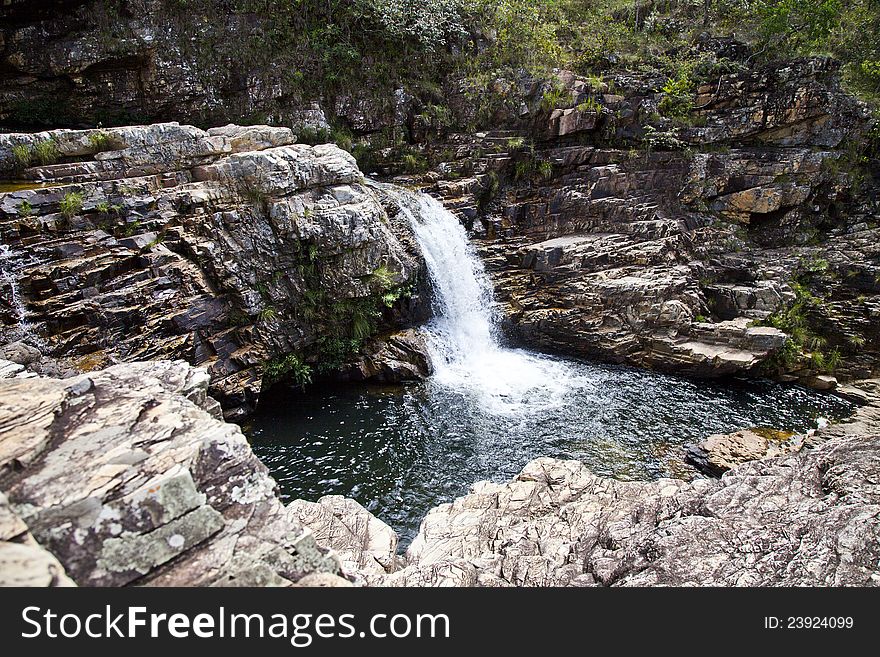 Small waterfall and lake with rocks