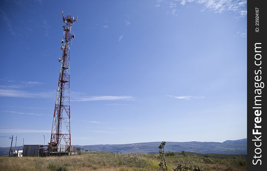 Bright blue sky and cell phone transmitter tower. Communication tower. Bright blue sky and cell phone transmitter tower. Communication tower.