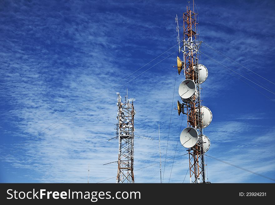 Bright blue sky and cell phone transmitter tower. Communication tower. Bright blue sky and cell phone transmitter tower. Communication tower.