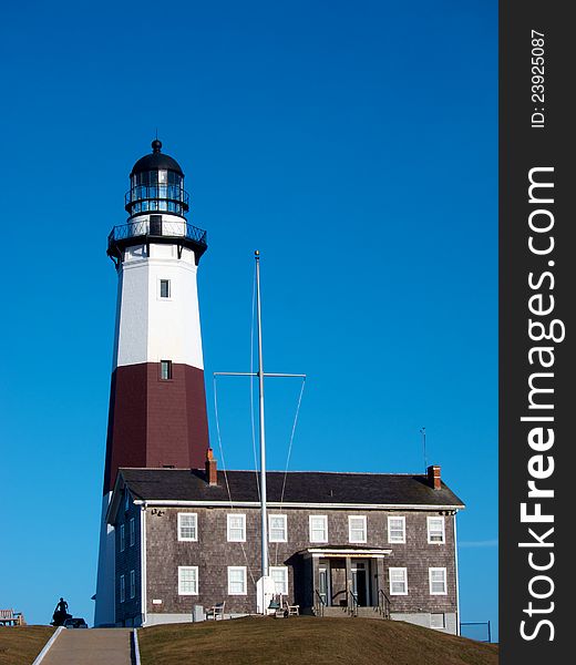 The lighthouse at Montauk Point, Long Island, is shown on a sunny day with a brilliant blue sky. The lighthouse at Montauk Point, Long Island, is shown on a sunny day with a brilliant blue sky.