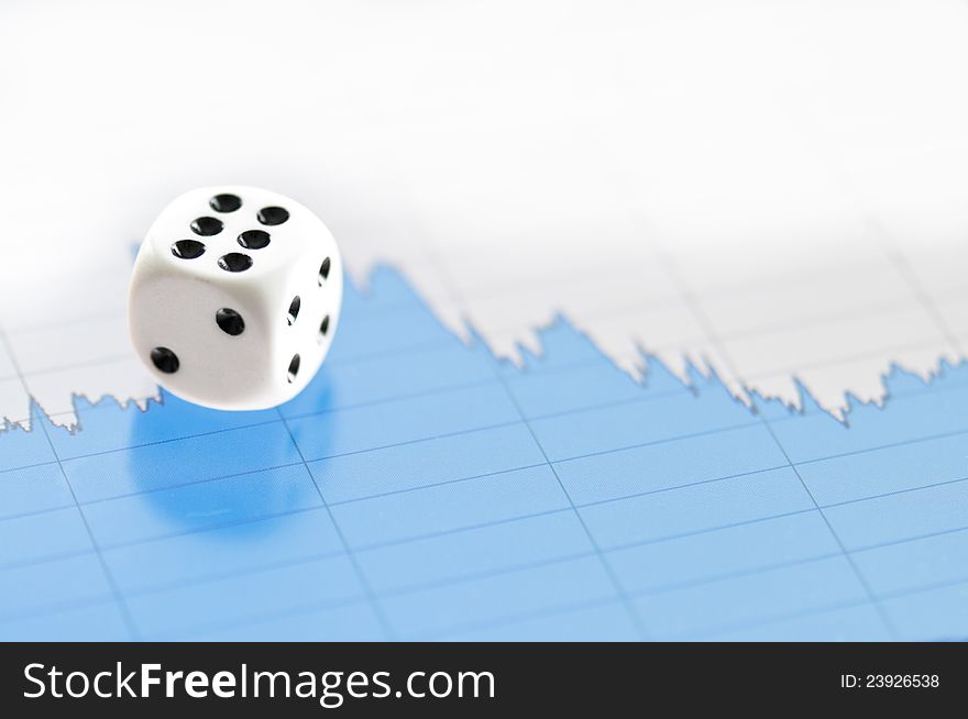 White dice on digital screen with financial chart showing uncertainity