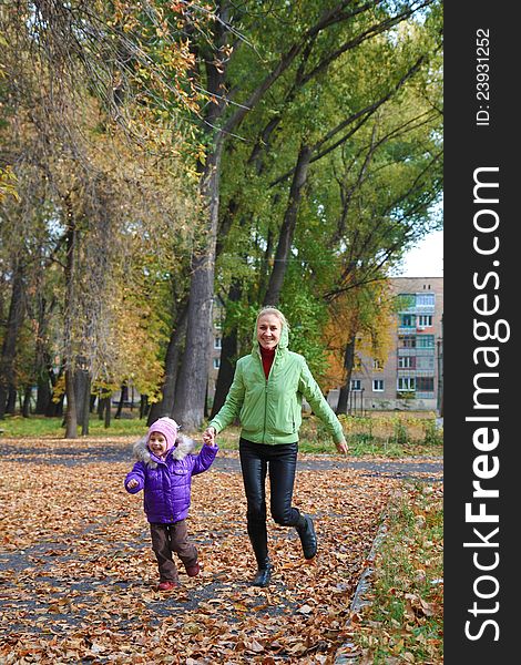 Woman  With Her Daughter In The Autumn Park