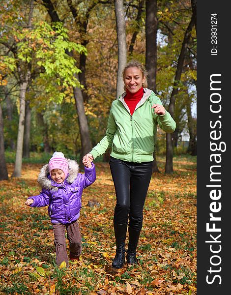 Woman  With Her Daughter In The Autumn Park