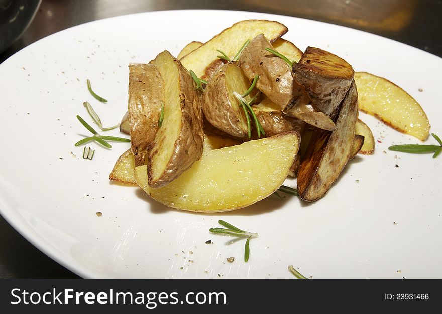 Baked potatoes are decorated with mint on a white plate. Baked potatoes are decorated with mint on a white plate