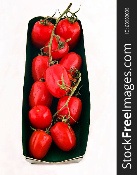 Pack of small tomatoes isolated on the white. Pack of small tomatoes isolated on the white