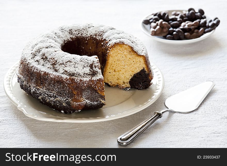 Photograph of a vanilla and chocolate cake on a plate. Photograph of a vanilla and chocolate cake on a plate
