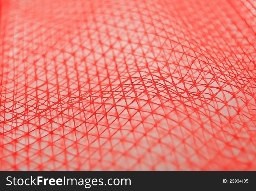 A piece of red nylon net. A piece of red nylon net