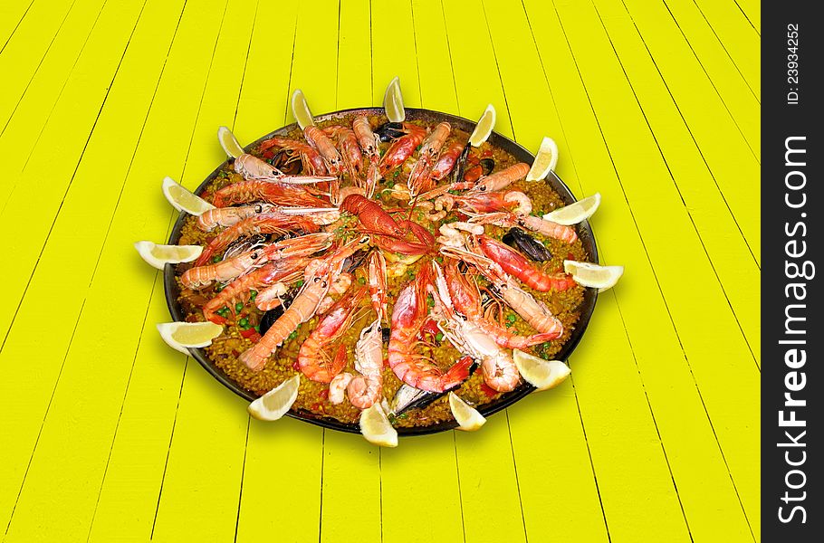 Colorful, tasty paella with lobsters and prawns