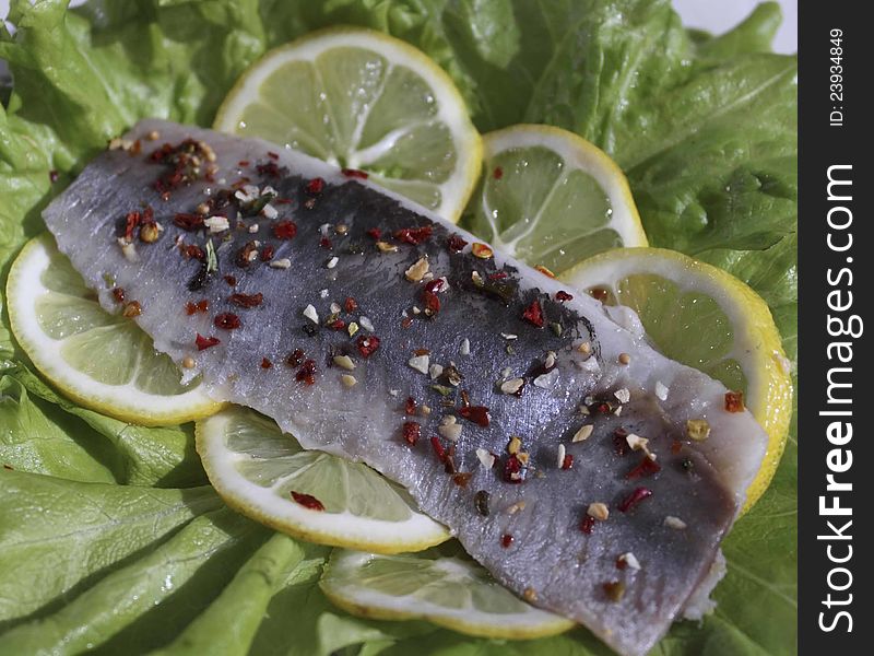 Herring with salad leaves and lemon