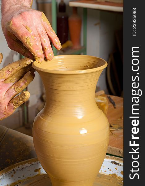 Craftsman making vase from fresh wet clay