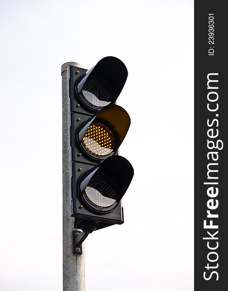 Yellow traffic light on white background