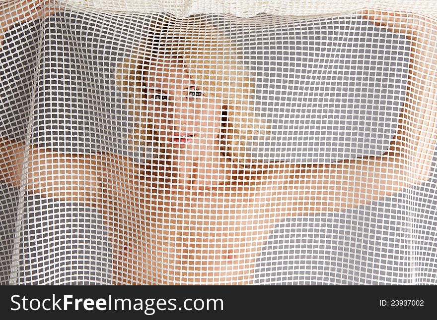 Nude Woman Looking Through Mesh Fabric