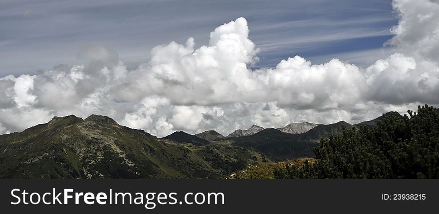 Alpine landscape panorama: mountain peaks and beautiful cloudy sky in Obertauern area, Austrian Alps, Europe. Alpine landscape panorama: mountain peaks and beautiful cloudy sky in Obertauern area, Austrian Alps, Europe
