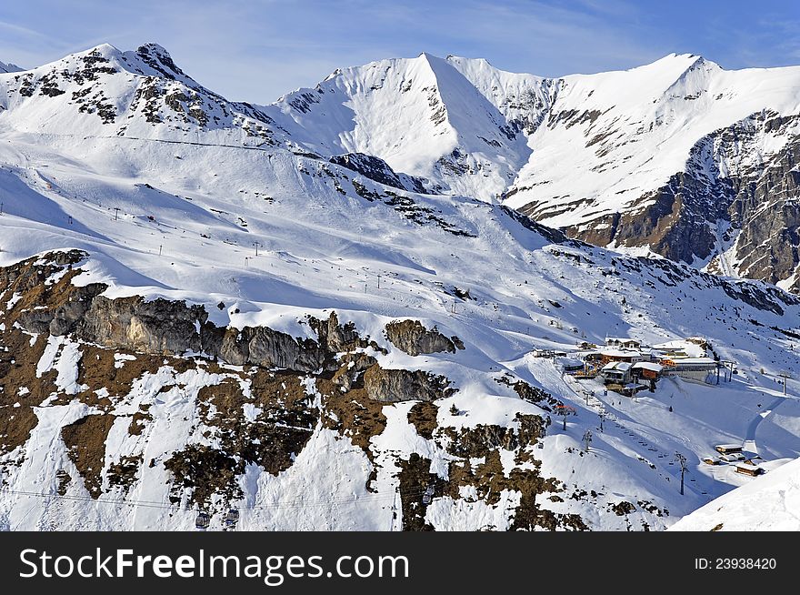 Zillertal Alps at Hintertux Glacier with a cable car station, ski lifts and pistes in sunset light. Zillertal Alps at Hintertux Glacier with a cable car station, ski lifts and pistes in sunset light