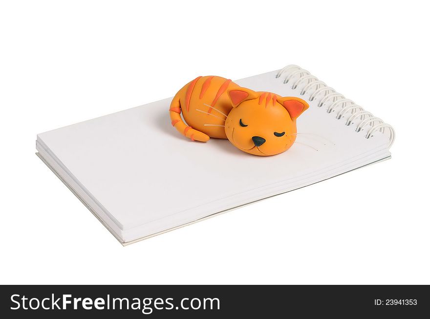Sculpture cat napping on note book
