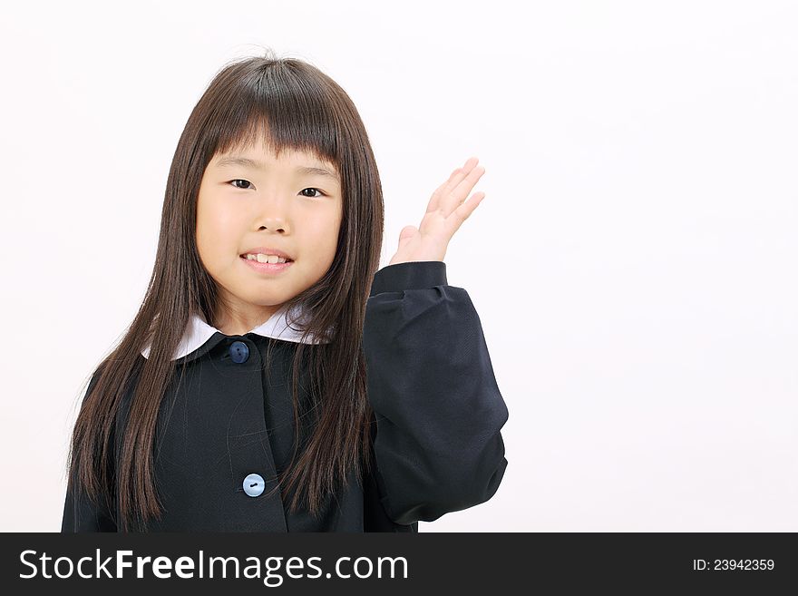 Little asian schoolgirl rise hand showing blank sign