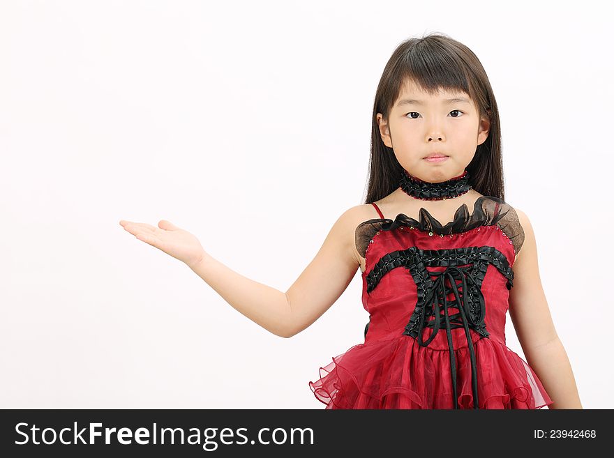 Little asian girl wearing dress, showing blank sign