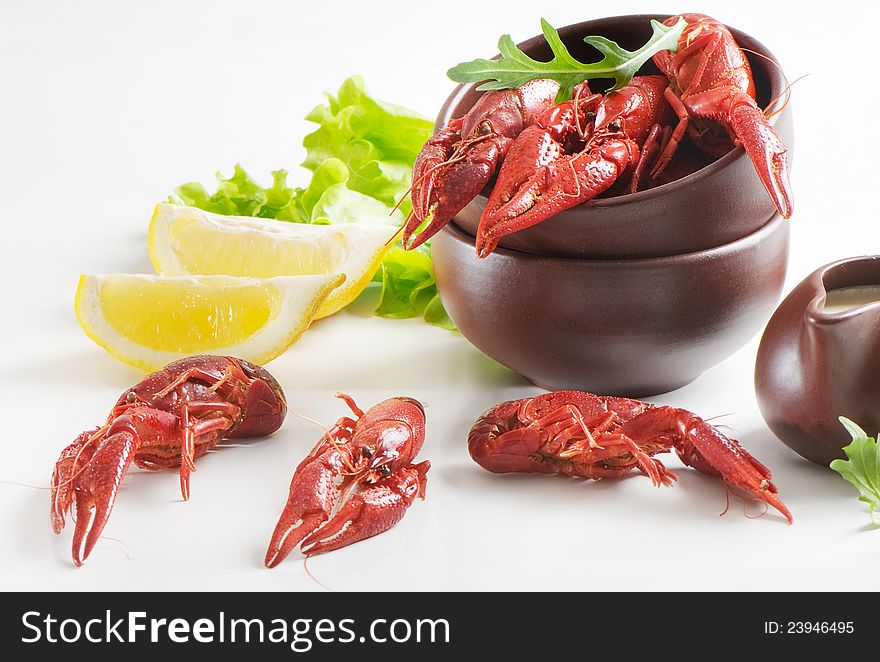 Boiled crawfish with lemon and fresh salad