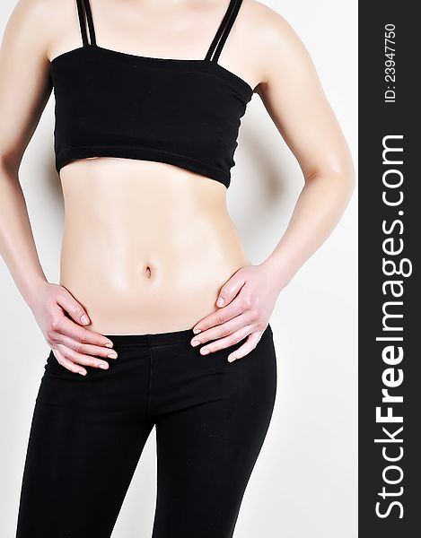 Female sporting body in a black tracksuit. Healthy lifestyles concept.