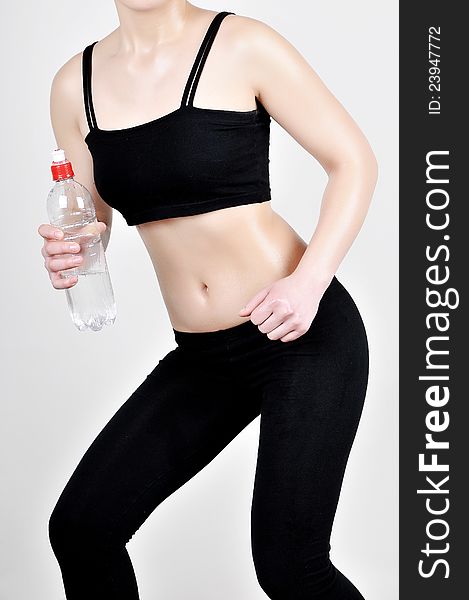 Front view of female sporting body in a black tracksuit. Healthy lifestyles concept.