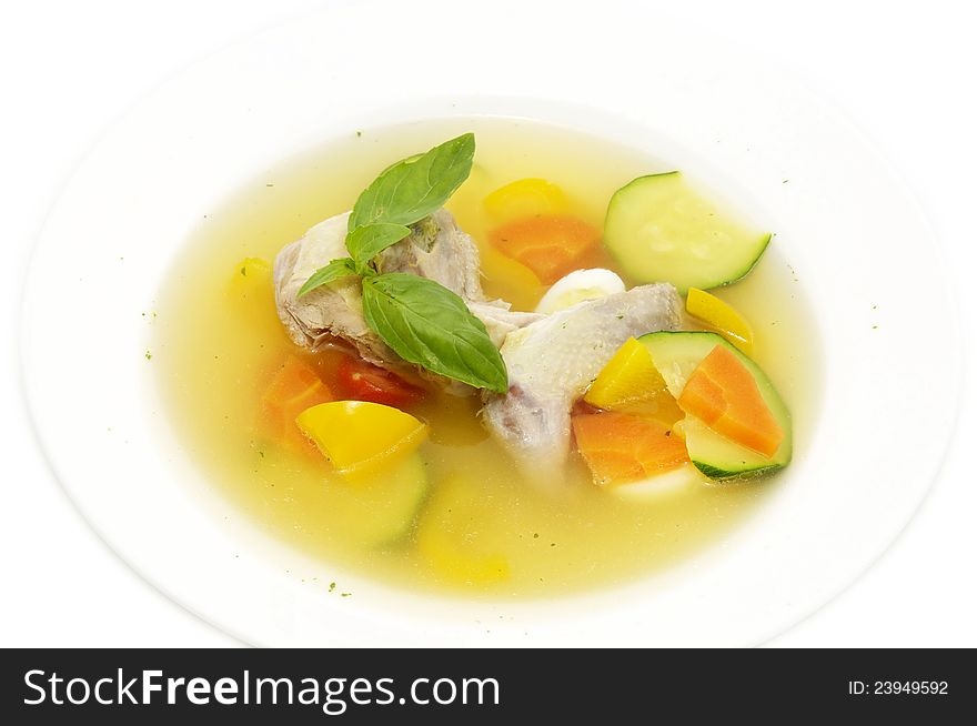 Quail broth with vegetables and herbs on a white background. Quail broth with vegetables and herbs on a white background