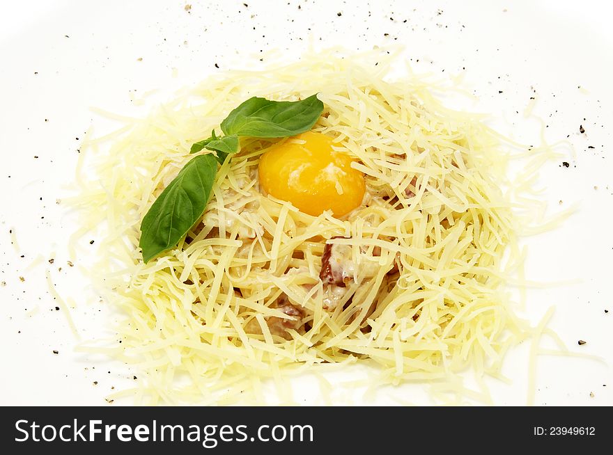 Spaghetti with egg and cheese on white plate