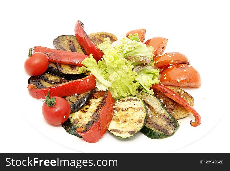 Grilled vegetables and greens on a white background