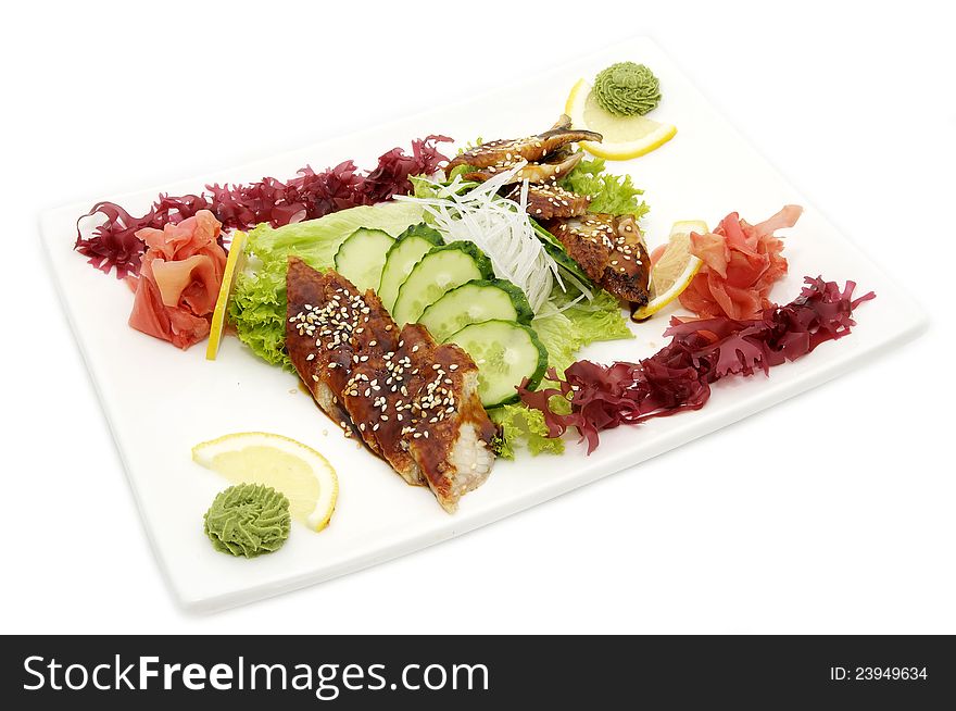 Fish and eel salad with vegetables on a white background. Fish and eel salad with vegetables on a white background