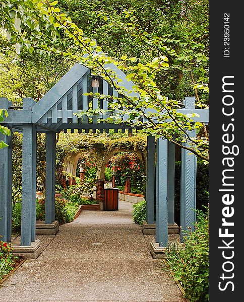 Blue wooden arch over botanical garden path