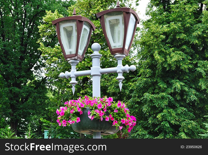 Park lamp with living colors among trees