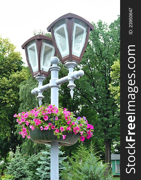 Park lamp with living colors among trees