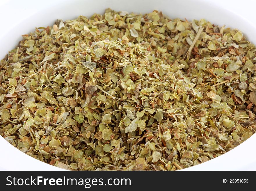 Closeup photo of a bowl of dried aromatic herb : Sweet Marjoram spice. Closeup photo of a bowl of dried aromatic herb : Sweet Marjoram spice