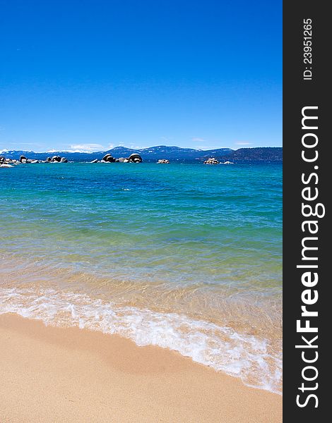 Views of Lake Tahoe in California with crystal clear water, snow on the ground, and mountains in the background. Views of Lake Tahoe in California with crystal clear water, snow on the ground, and mountains in the background.