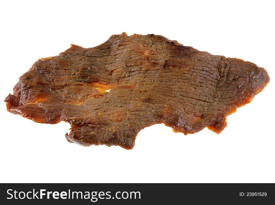 A piece of dried salty Beef Jerky (Lean meat), with herbs isolated on white background