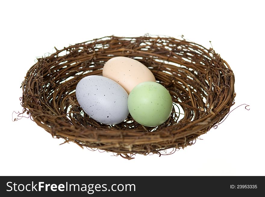 Colorful speckled animal eggs in a nest, isolated on white. Colorful speckled animal eggs in a nest, isolated on white.