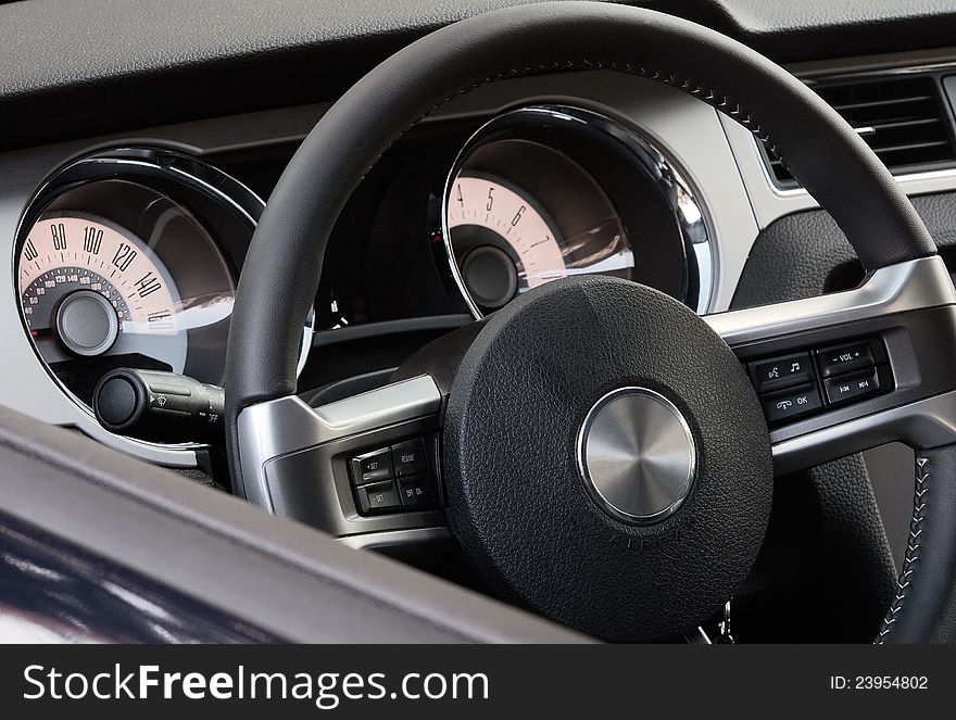 Dark colored dashboard of modern car made in retro style