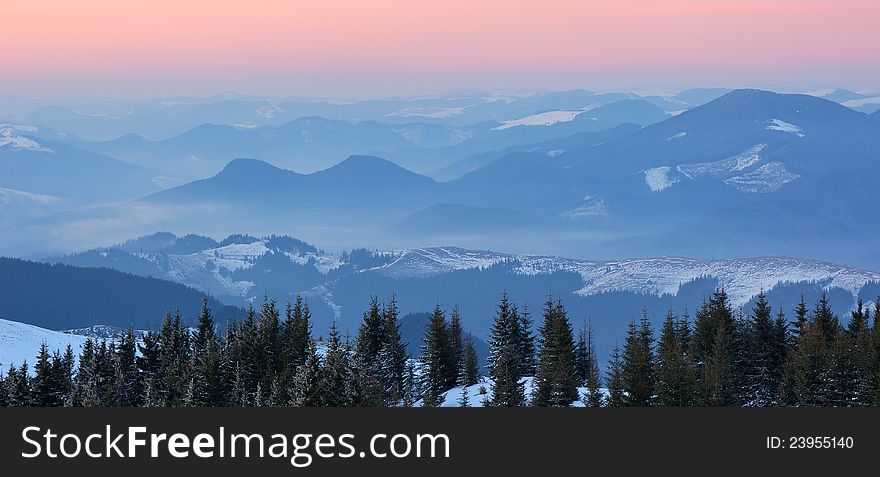 Winter landscape in the mountains at sunset with red sky. Ukraine, Carpathian Mountains. Winter landscape in the mountains at sunset with red sky. Ukraine, Carpathian Mountains