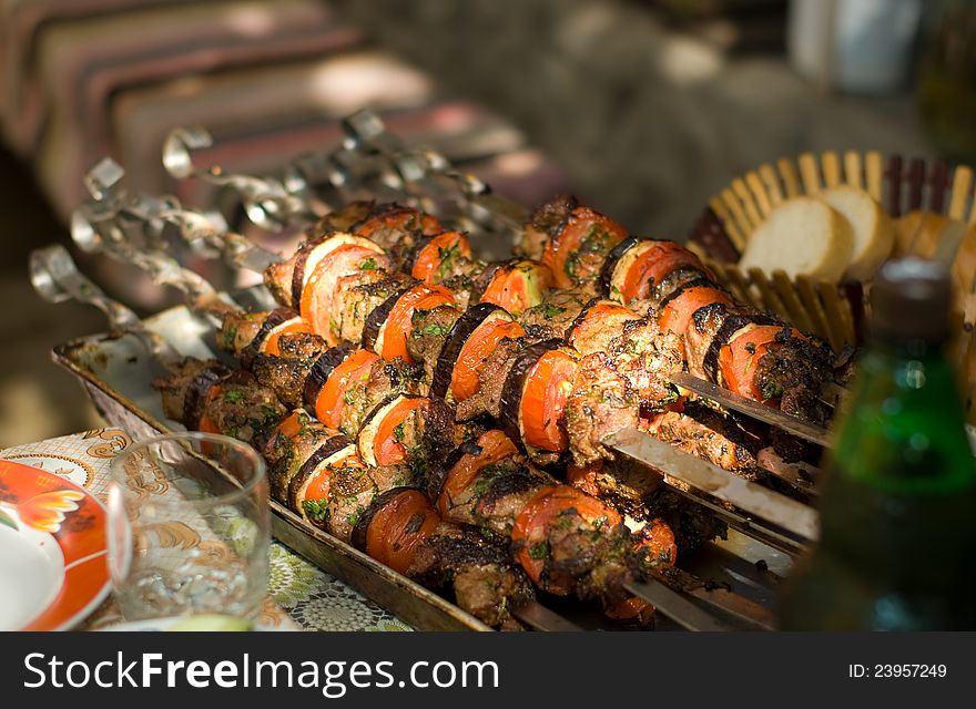 Kebab skewers with vegetables on a table close-up