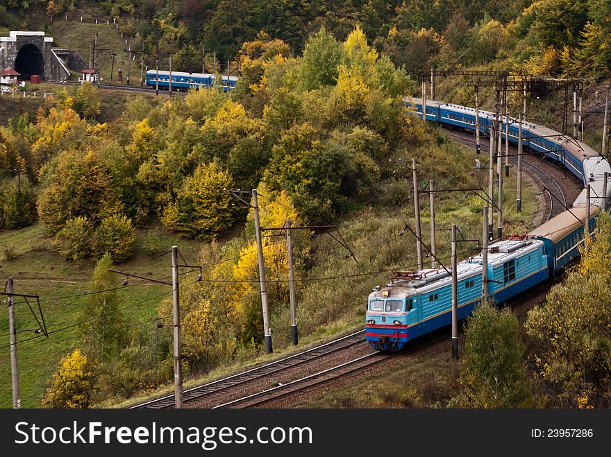 Electric locomotive with passenger cars in Carpathian mountains