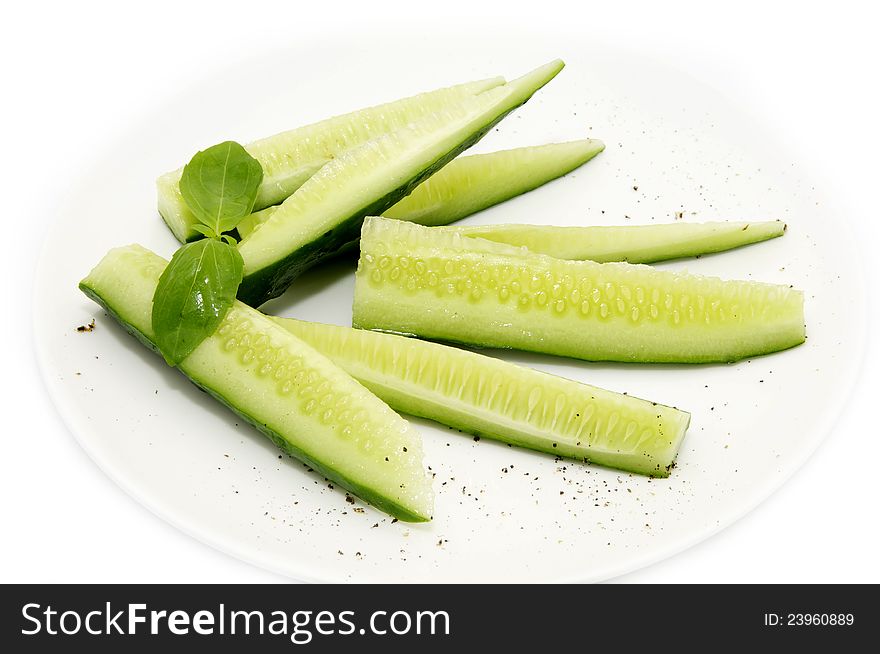 Sliced cucumber on a plate on a white background