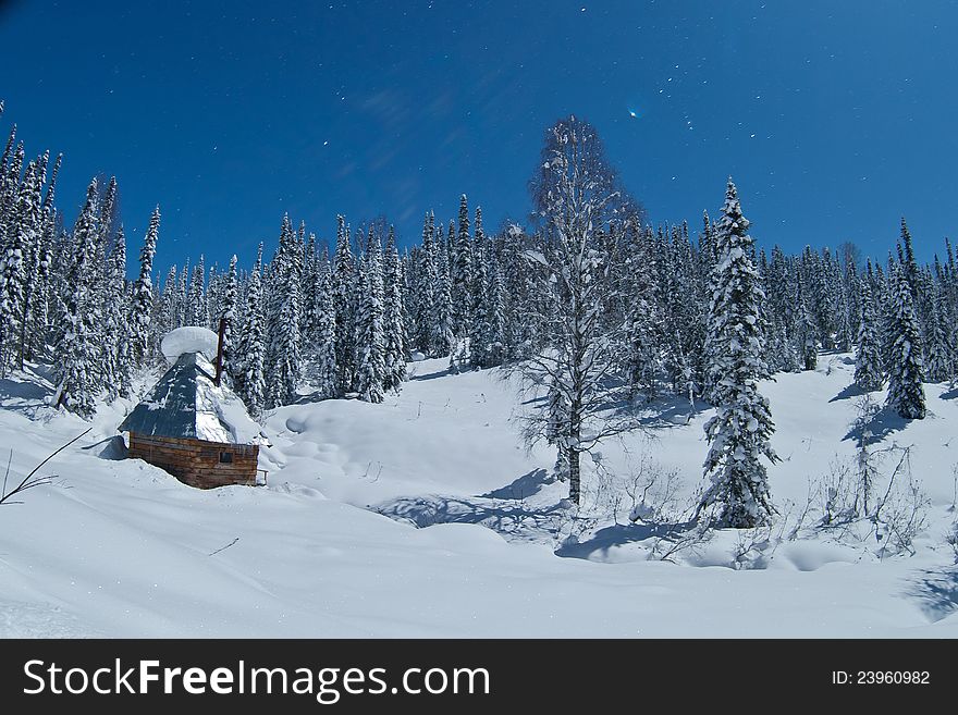 Small house in winter forest in Siberia