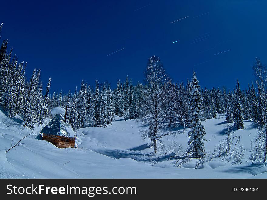 Small house in winter forest in Siberia