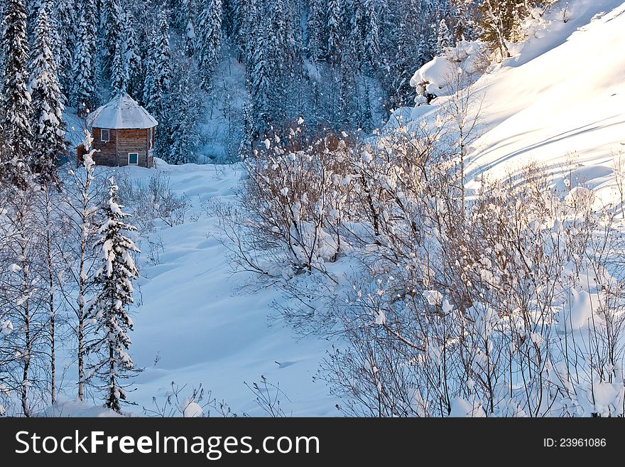 Small house in winter forest in Siberia