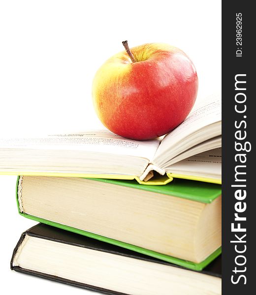 Book stack and apple on a white background. Book stack and apple on a white background