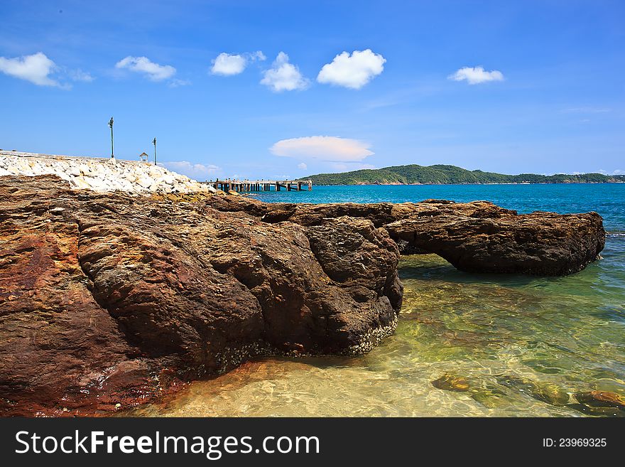 Sea beach and rock on blue sky as background