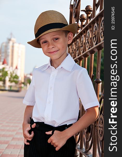A little boy in a retro hat on a background of the city. Portrait of a Boy. A little boy in a retro hat on a background of the city. Portrait of a Boy.