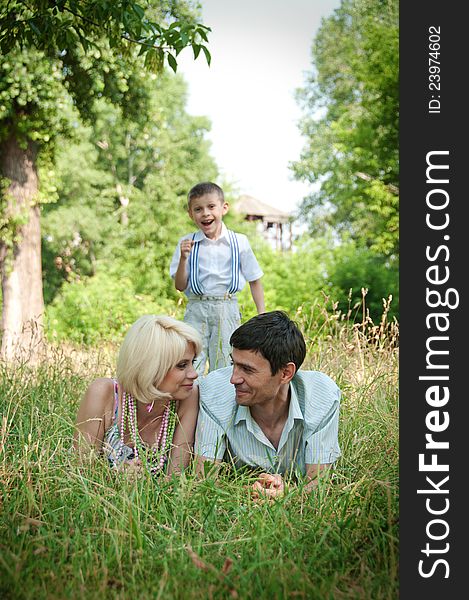 Portrait of happy family lying down on grass. Portrait of happy family lying down on grass.