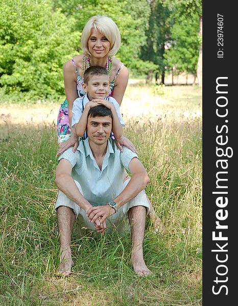 Portrait of happy family lying down on grass. Portrait of happy family lying down on grass.