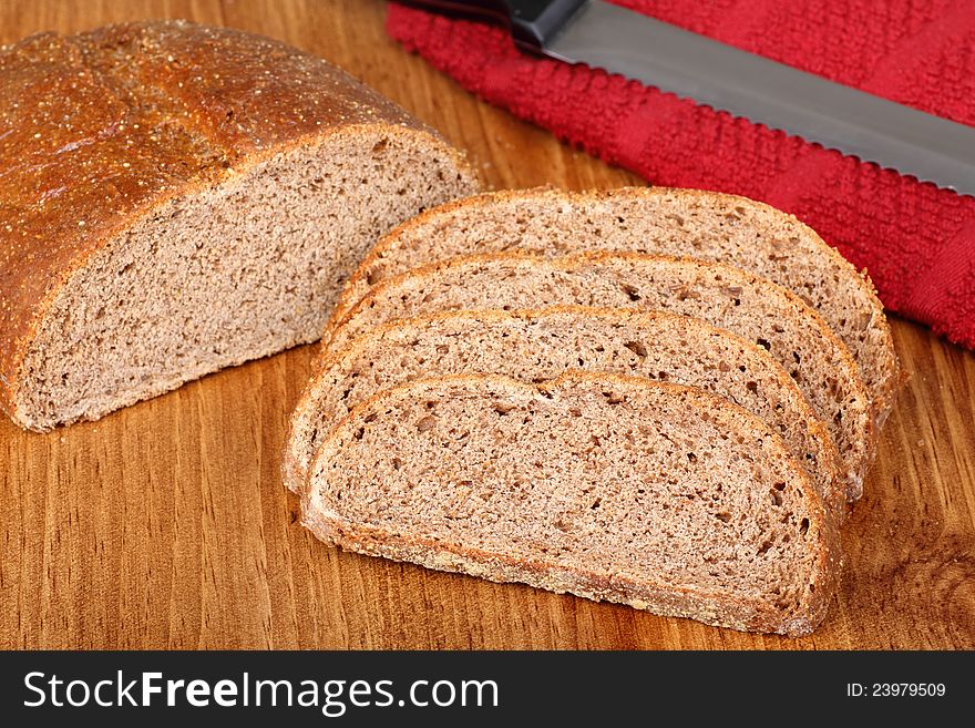 Rye bread loaf with slices on a cutting board. Rye bread loaf with slices on a cutting board