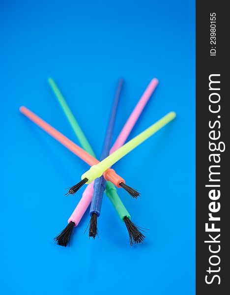 Colorful Plastic Paint Brushes on Blue Background. Colorful Plastic Paint Brushes on Blue Background